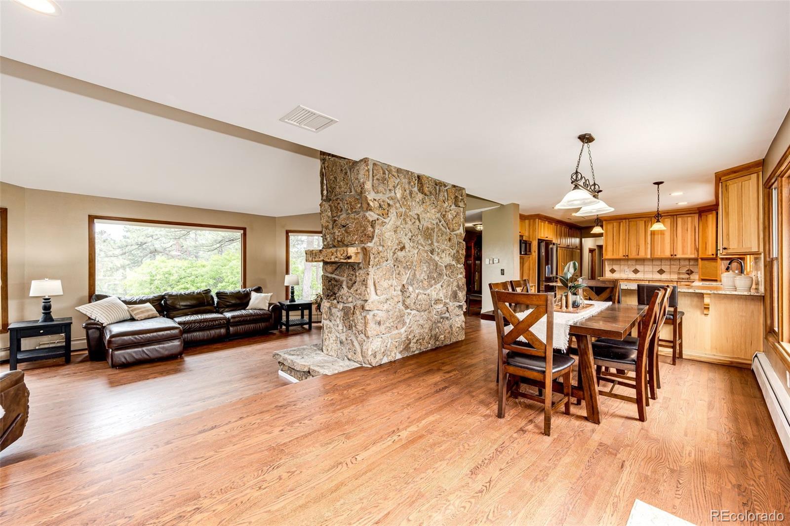 8788 East Tanglewood Road Franktown, CO 80116 - Photo 10 of 48 a view of a dining room with furniture window and wooden floor