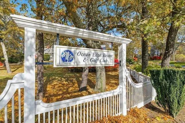 a car parked in front of a house with wooden fence