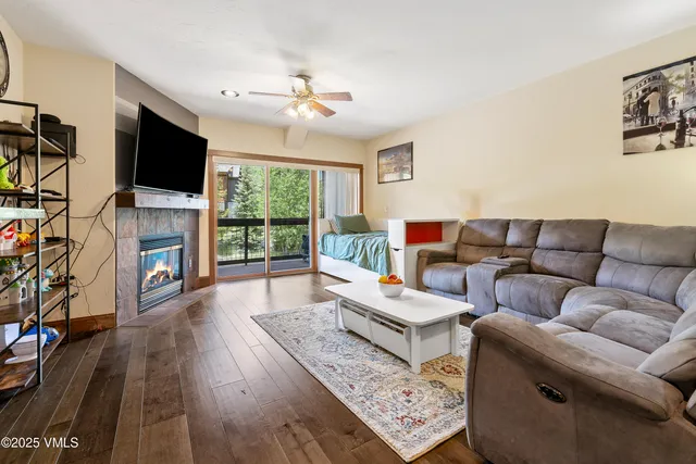 a living room with furniture fireplace and flat screen tv