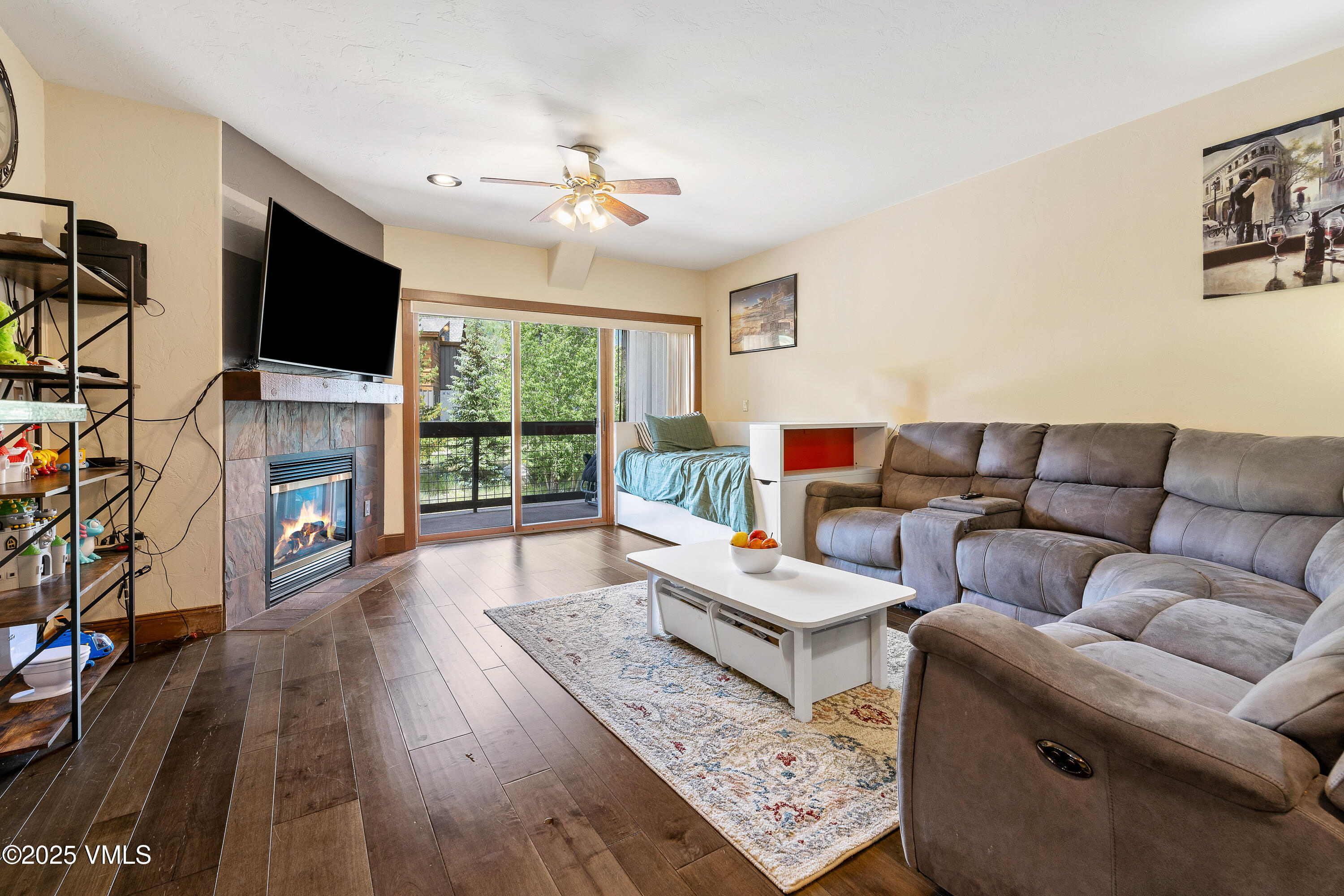 a living room with furniture fireplace and flat screen tv