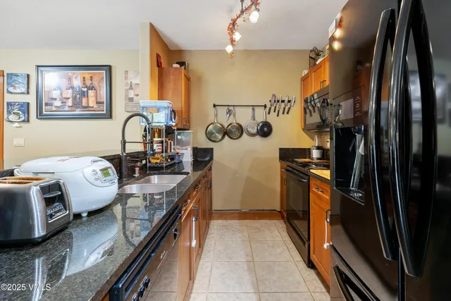 a kitchen with refrigerator and window