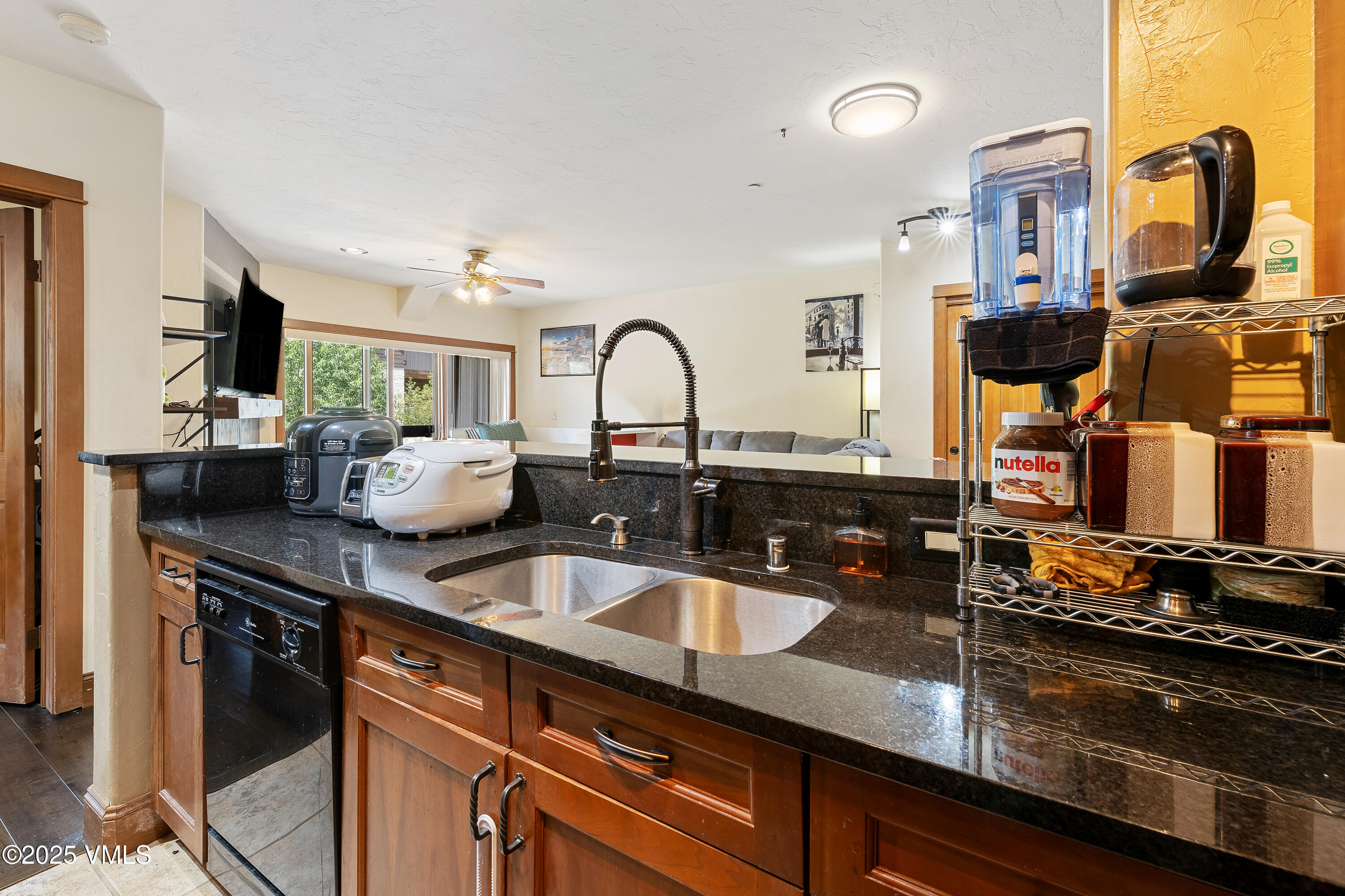 22787 Highway 6, Unit 207 Dillon, CO 80435 - Photo 14 of 44 a kitchen with a sink and a stove top oven with wooden floor