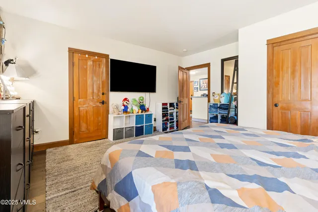 a bedroom with a bed and a flat screen tv