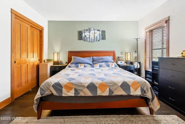 a bedroom with a bed and window