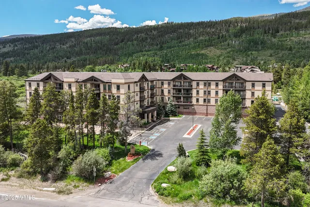 a view of a house with a yard and garden