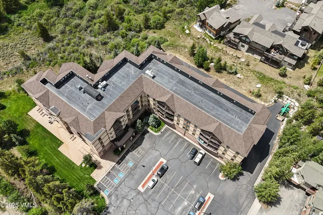 an aerial view of a house with a yard