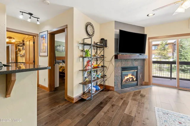 a living room with furniture a flat screen tv and a fireplace