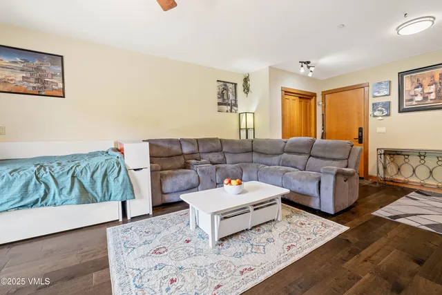 a living room with furniture and painting on the wall