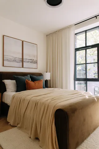 a bedroom with a bed and window