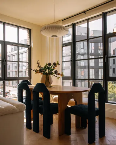 a living room filled with furniture and a large window