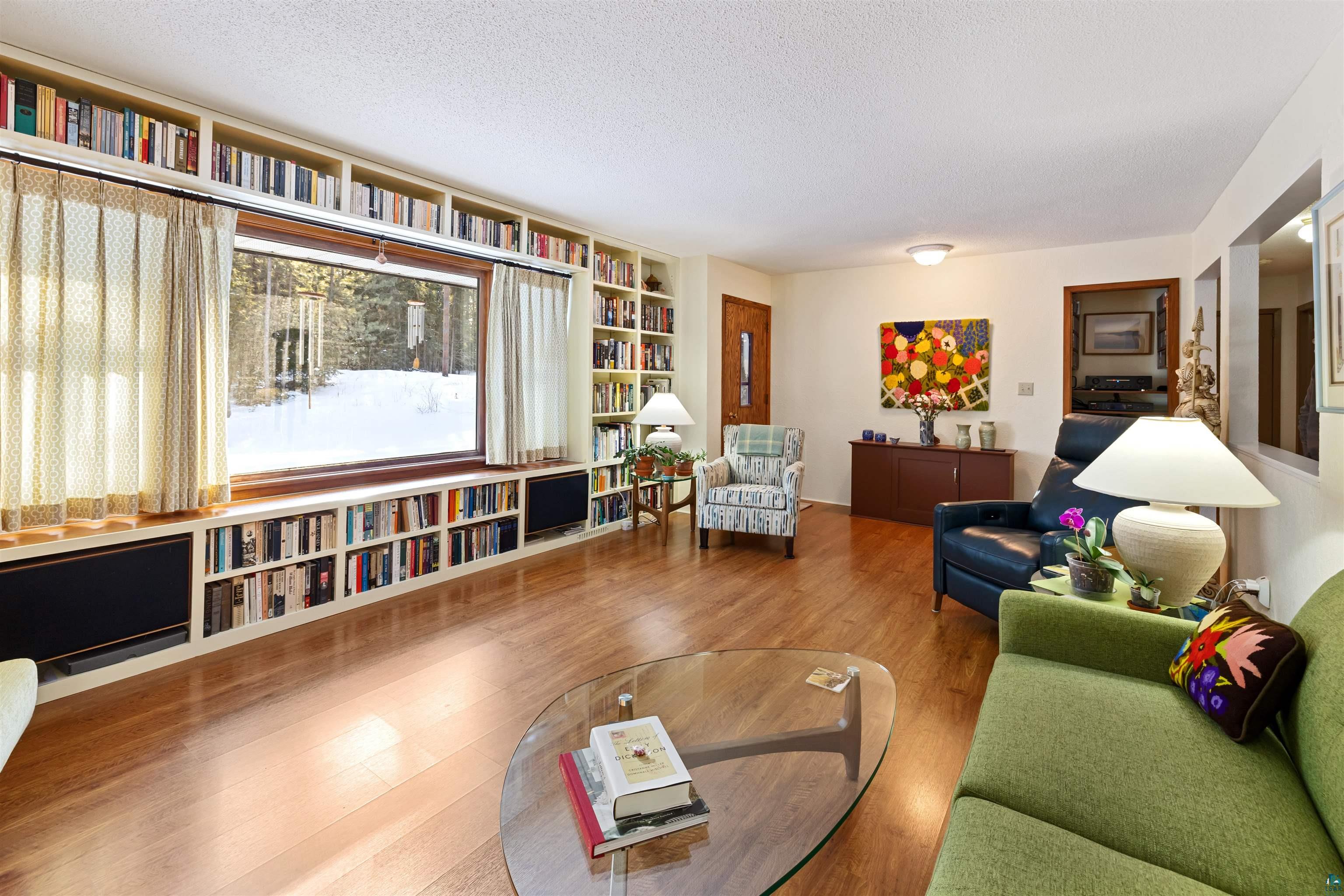 7193 Old Road, Unit 7 Virginia, MN 55792 - Photo 5 of 47 Living area featuring custom built-in bookcases and laminate wood finished floors