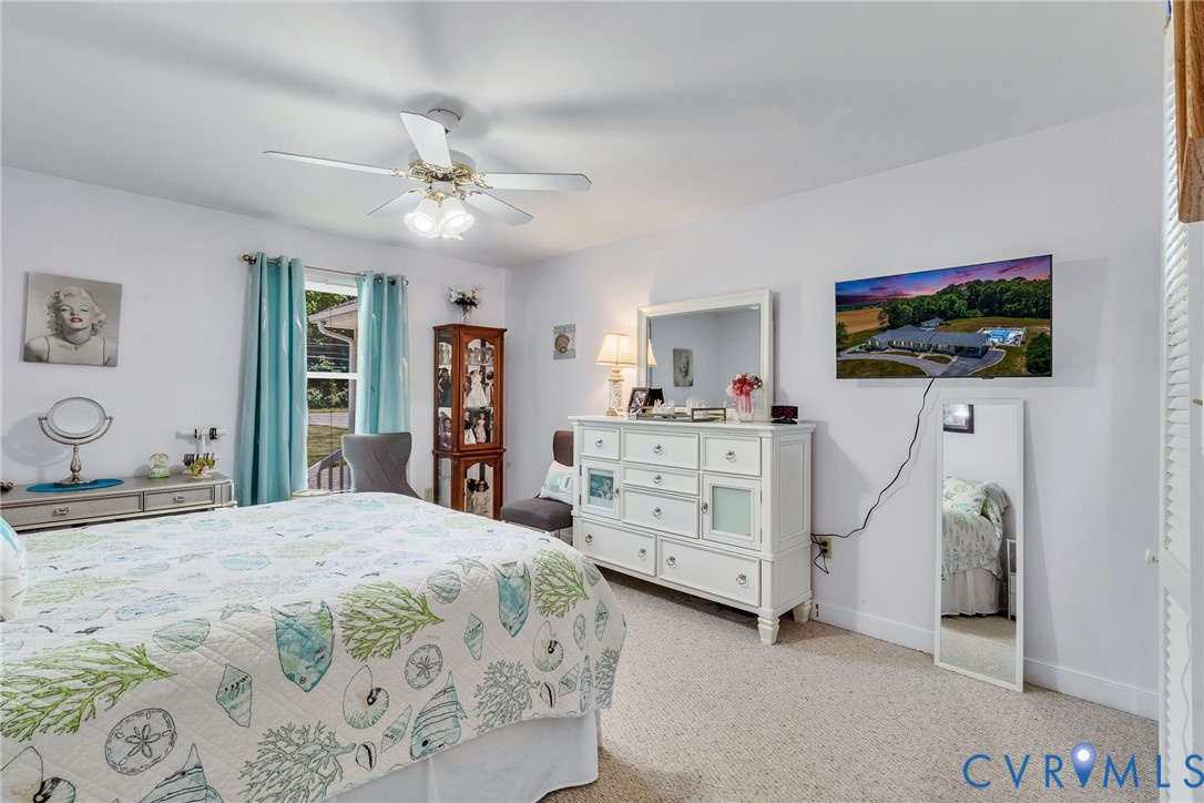 4400 Hacks Neck Road Heathsville, VA 22473 - Photo 25 of 78 a bedroom with a bed and a flat screen tv