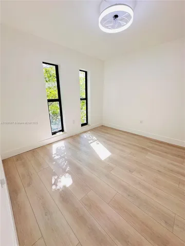 an empty room with windows and entrance