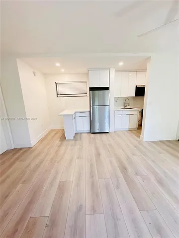 a view of a kitchen with wooden floor and a sink