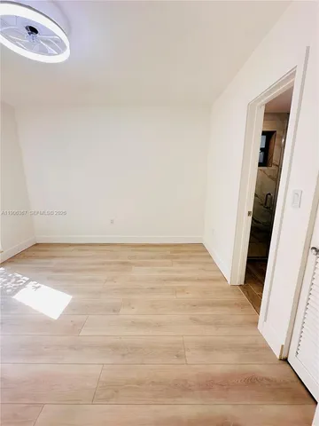 a view of an empty room and wooden floor