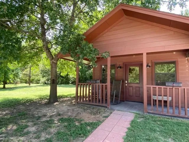 a view of a house with backyard and a tree