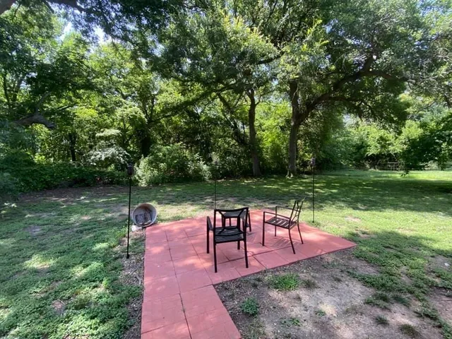 a wooden bench sitting in the middle of a garden