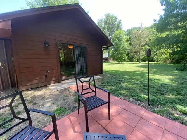 a view of a backyard with sitting area