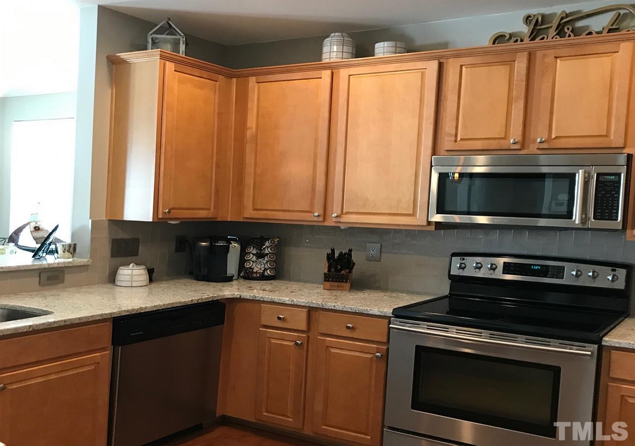 5402 Silver Moon Lane Raleigh, NC 27606 - Photo 4 of 25 Lovely updated kitchen with new glass tile back splash and granite counter tops