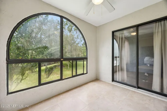 an empty room with large windows and painted walls
