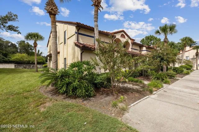 a view of a street with potted plants