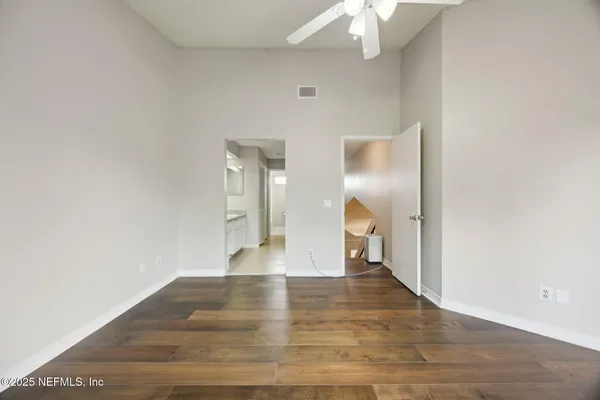 a view of empty room with wooden floor