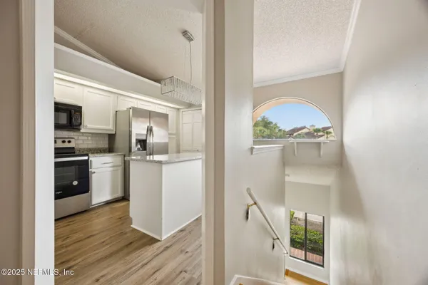 a view of a kitchen cabinets and wooden floor