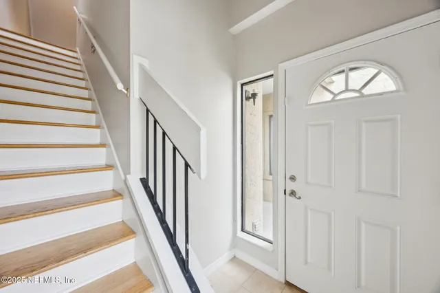 a view of a livingroom with wooden floor and entryway