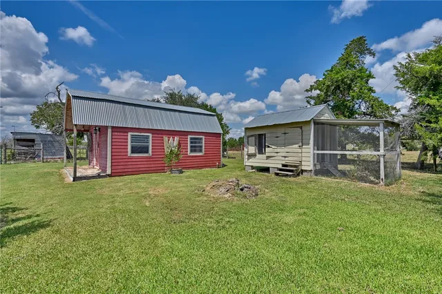 a view of a chair and table in the garden
