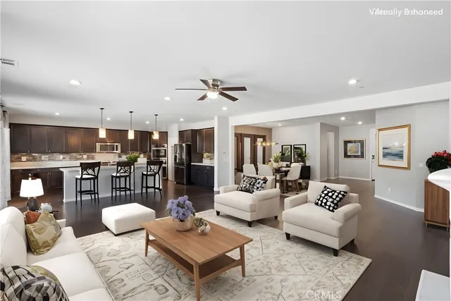 a living room with furniture kitchen view and a table