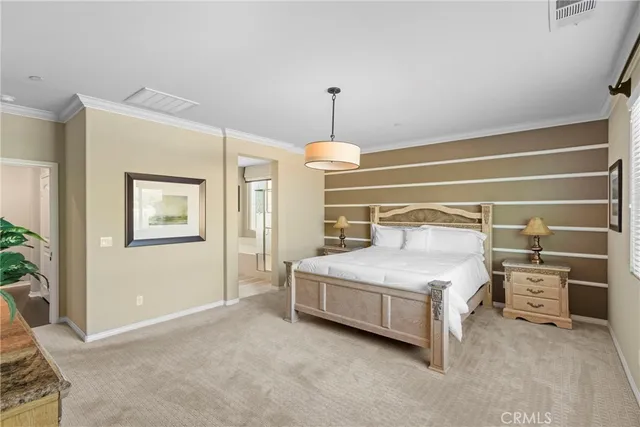 a spacious bedroom with a bed and a cabinets