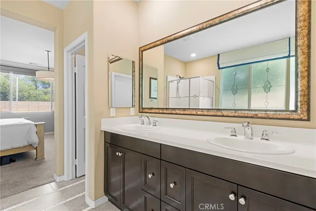 a bathroom with a sink double vanity and a mirror