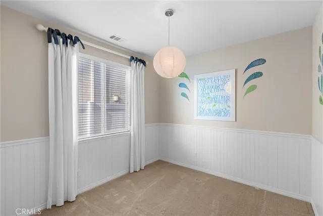 an empty room with windows and entrance