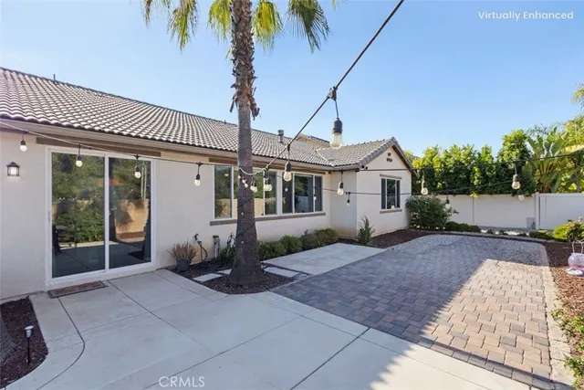 a front view of a house with a yard and potted plants