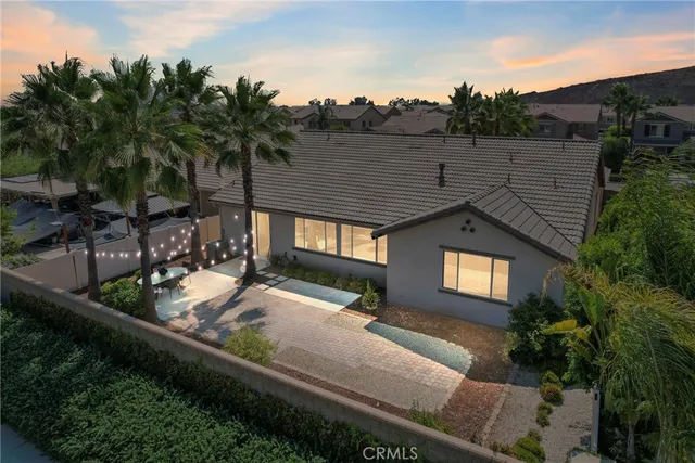 a view of house with a yard and potted plants