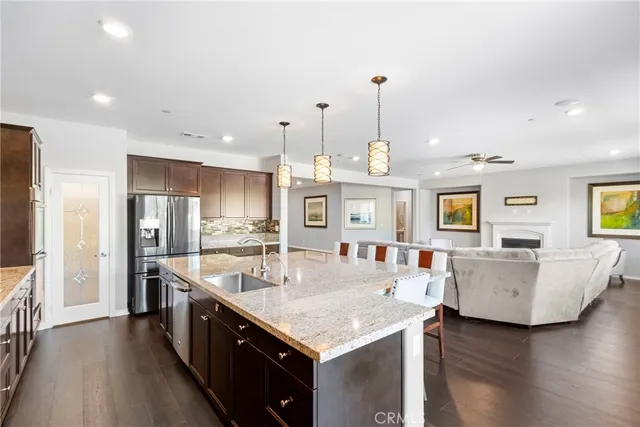 a kitchen with stainless steel appliances granite countertop a sink stove and wooden floor