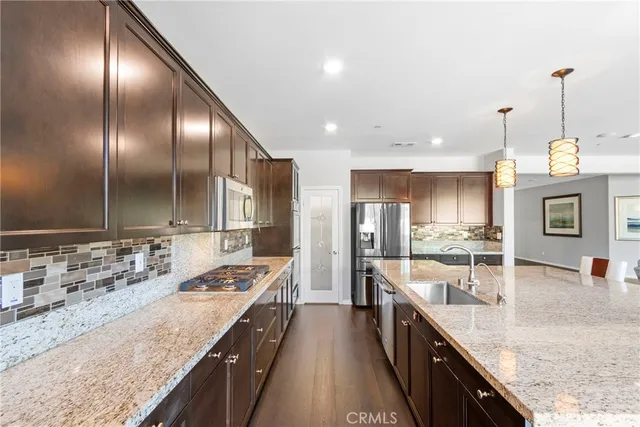 a kitchen with stainless steel appliances granite countertop counter space a sink and cabinets