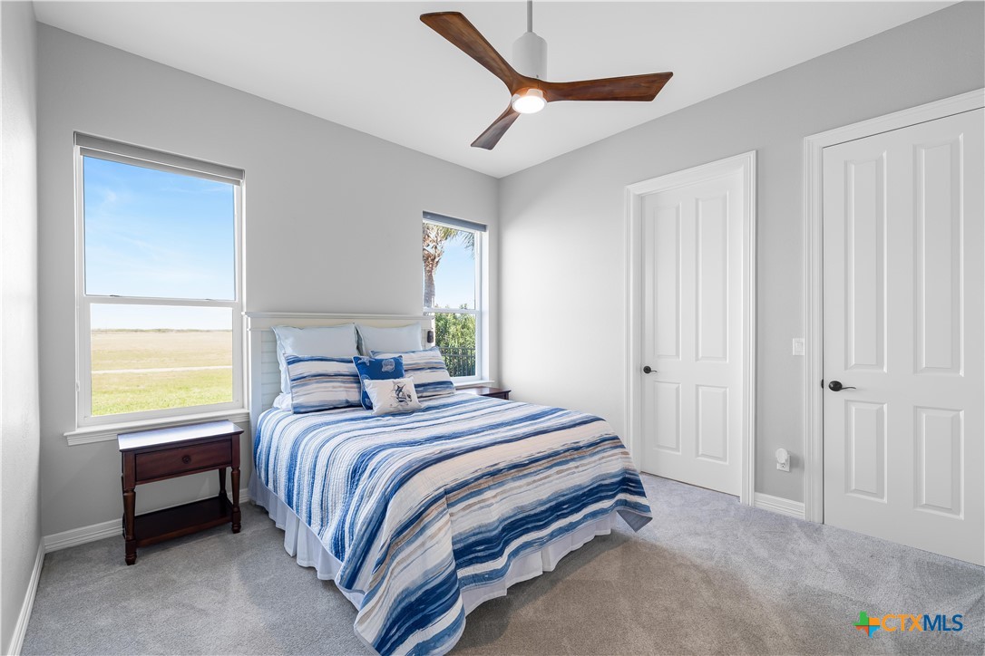 559 West Lago Loop Road Port O'Connor, TX 77982 - Photo 19 of 44 a bedroom with a bed and a window