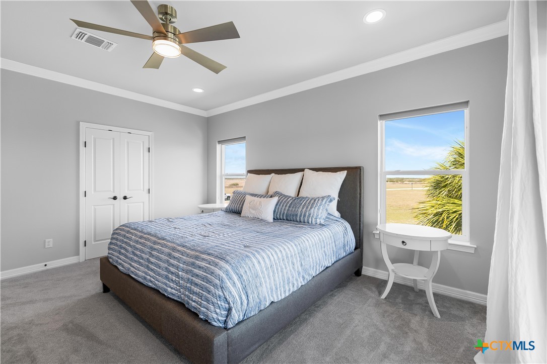 559 West Lago Loop Road Port O'Connor, TX 77982 - Photo 27 of 44 a bedroom with a bed and a window