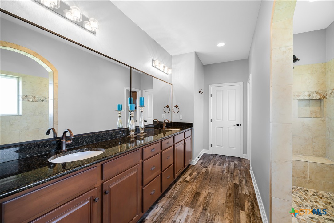 559 West Lago Loop Road Port O'Connor, TX 77982 - Photo 29 of 44 a spacious bathroom with a double vanity sink and a mirror