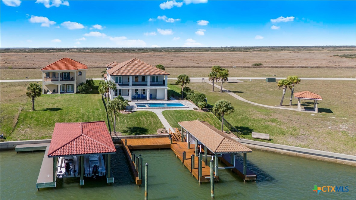 559 West Lago Loop Road Port O'Connor, TX 77982 - Photo 34 of 44 an aerial view of a house with swimming pool outdoor seating and yard