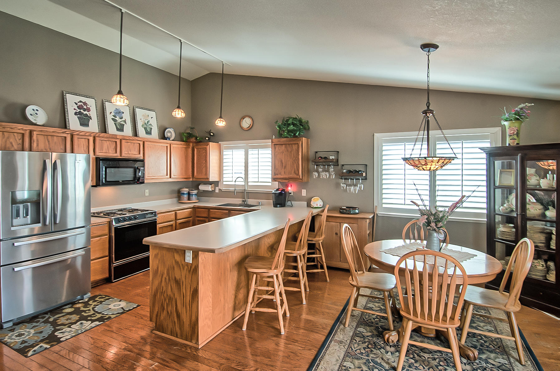 1566 Lavender Way Redding, CA 96003 - Photo 12 of 36 a kitchen with stainless steel appliances granite countertop a stove top oven a dining table and chairs with the wooden floor