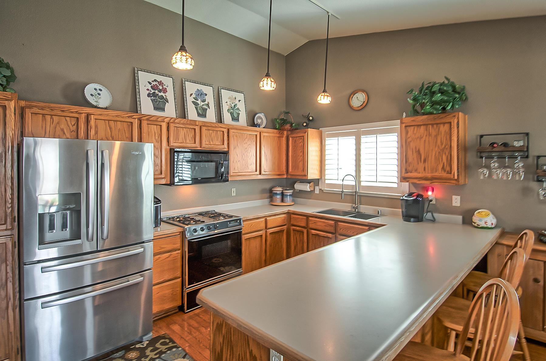 1566 Lavender Way Redding, CA 96003 - Photo 13 of 36 a kitchen with stainless steel appliances granite countertop a sink a stove and a refrigerator