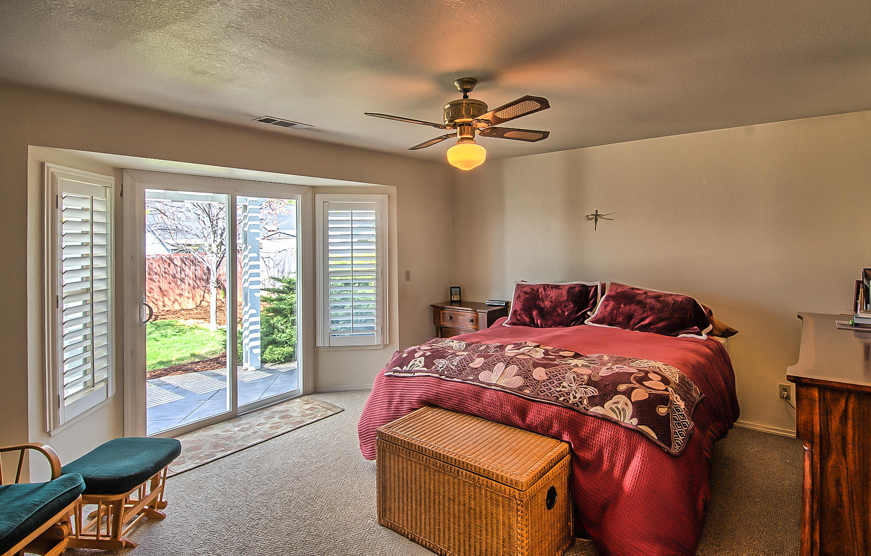 1566 Lavender Way Redding, CA 96003 - Photo 23 of 36 a bedroom with a bed and a chandelier