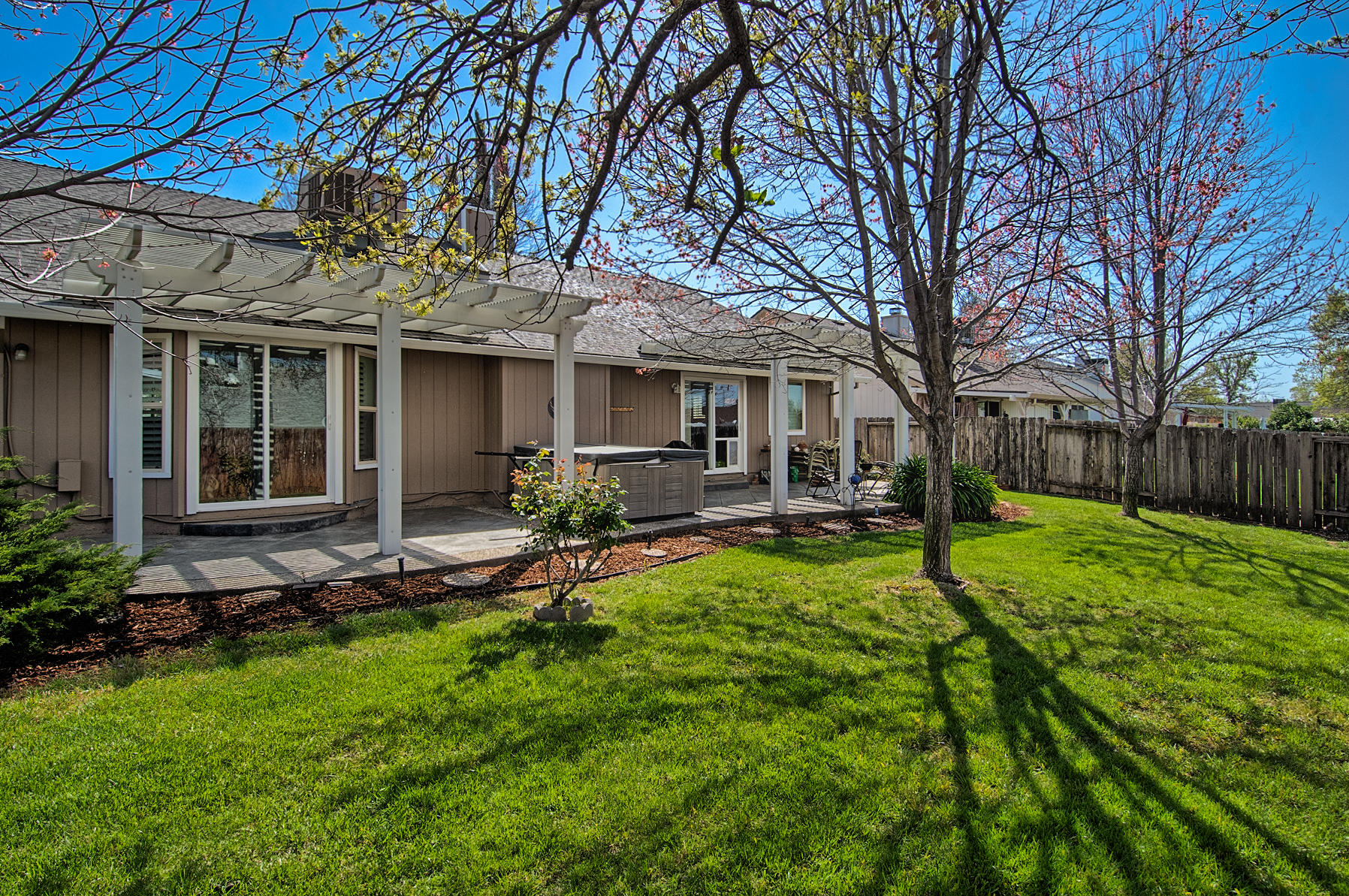 1566 Lavender Way Redding, CA 96003 - Photo 34 of 36 a view of a backyard with table and chairs and a fire pit