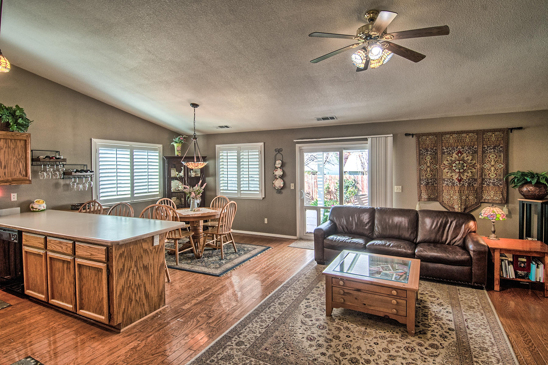 1566 Lavender Way Redding, CA 96003 - Photo 8 of 36 a living room with furniture a chandelier and a window