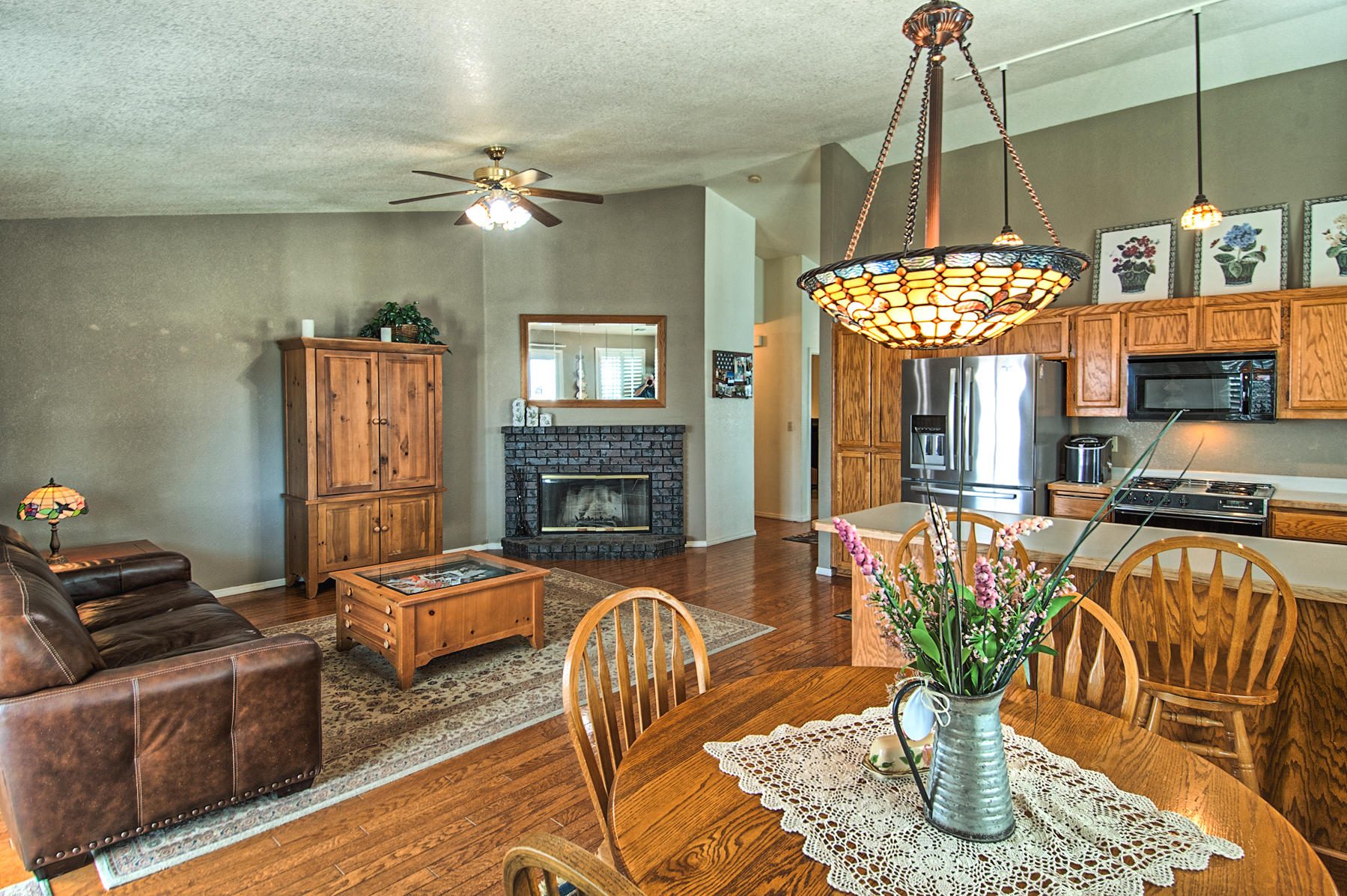1566 Lavender Way Redding, CA 96003 - Photo 10 of 36 a living room with furniture a chandelier and a fireplace