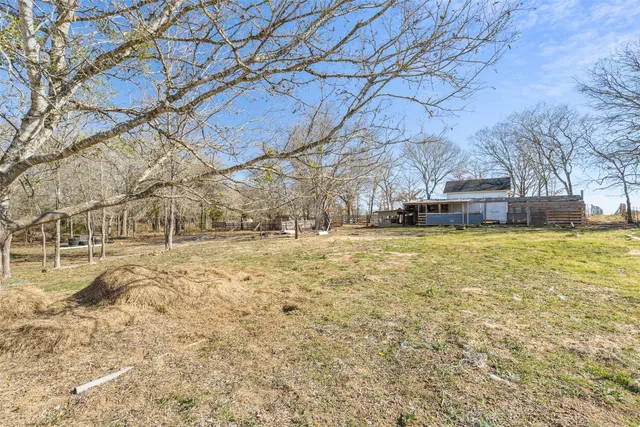 a view of yard with wooden fence