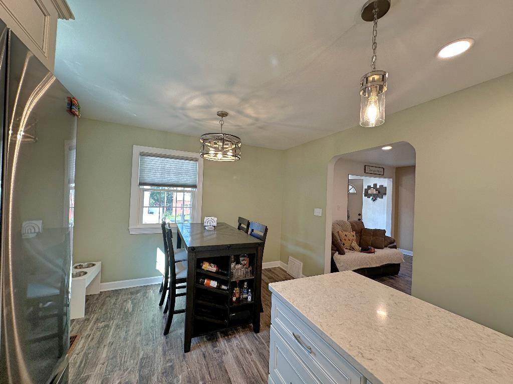 318 Vanadium Road Pittsburgh, PA 15243 - Photo 13 of 30 a dining room with wooden floor a chandelier a wooden table and chairs
