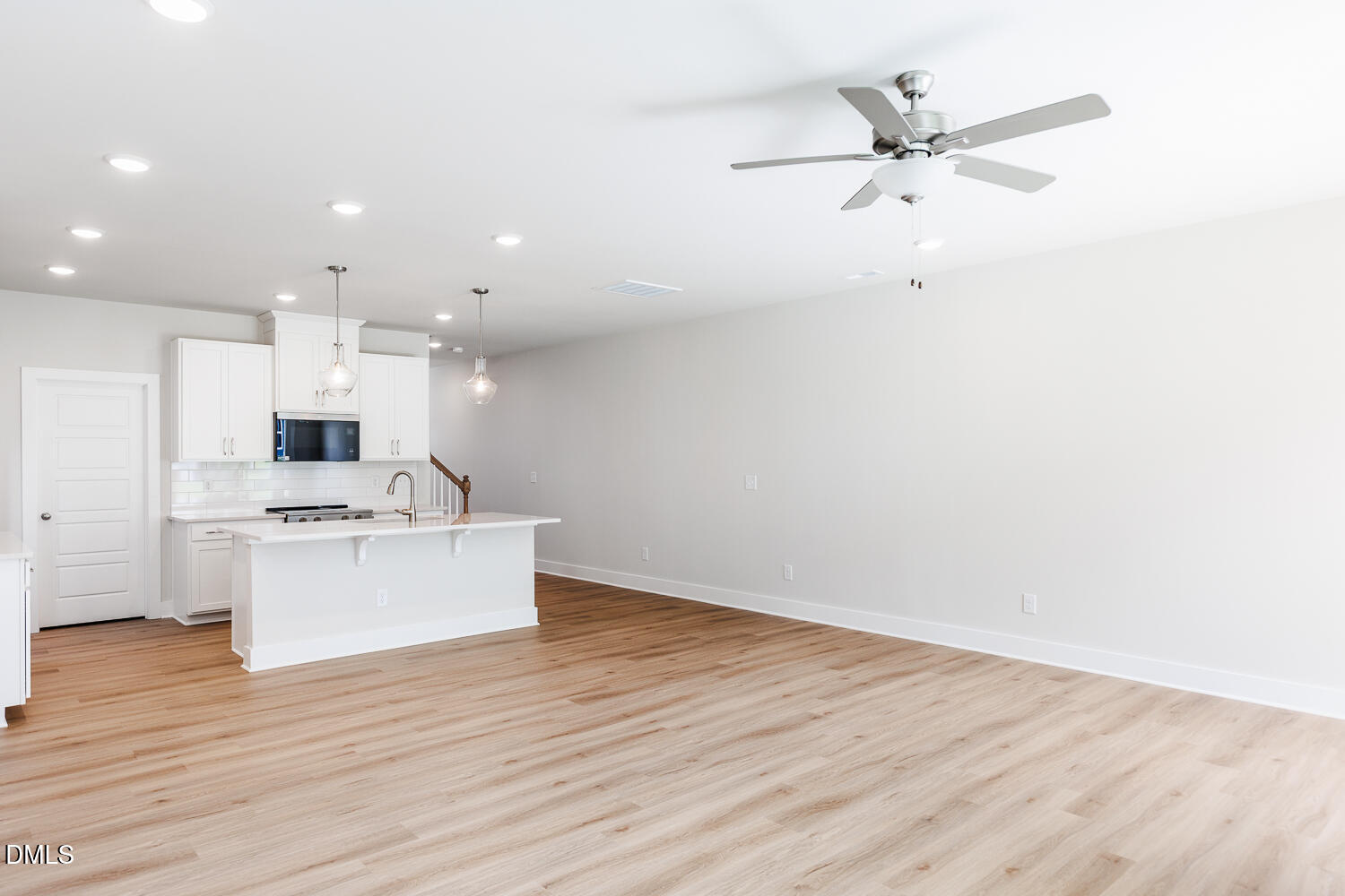 a view of kitchen with sink and wooden floor